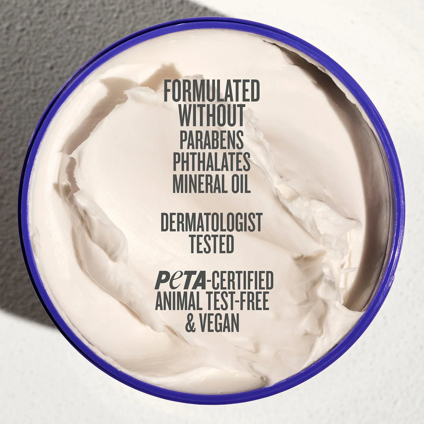 Jar of cream with certification text on a neutral background