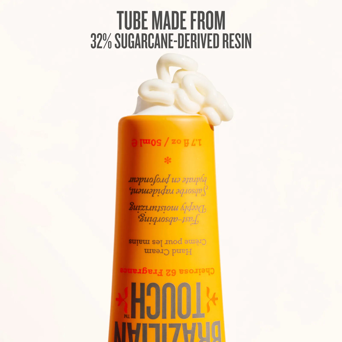 Shampoo bottle with whipped cream on a white background, featuring text about sugarcane-derived resin.